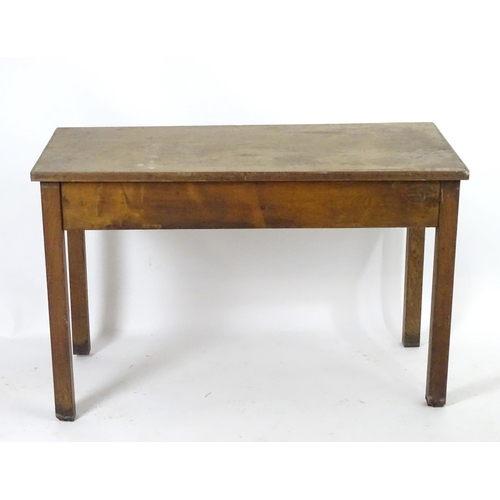 1563 - A mid 20thC fruitwood and oak desk with a rectangular top above a single short drawers and raised on... 