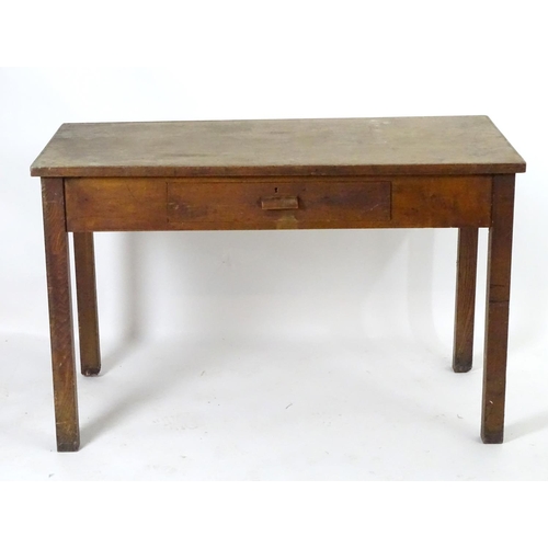 1563 - A mid 20thC fruitwood and oak desk with a rectangular top above a single short drawers and raised on... 