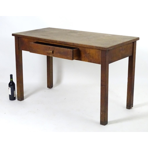 1563 - A mid 20thC fruitwood and oak desk with a rectangular top above a single short drawers and raised on... 