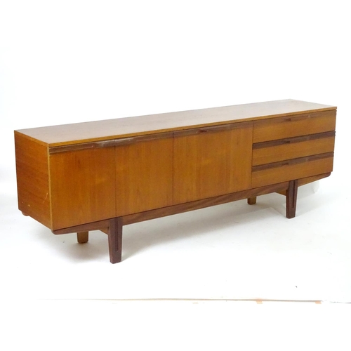 1565 - Vintage retro, mid-century: a large c1970 teak sideboard, in the Danish style, the three compartment... 