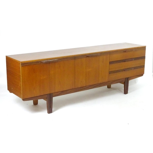 1565 - Vintage retro, mid-century: a large c1970 teak sideboard, in the Danish style, the three compartment... 