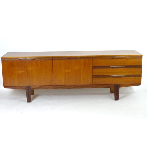 1565 - Vintage retro, mid-century: a large c1970 teak sideboard, in the Danish style, the three compartment... 