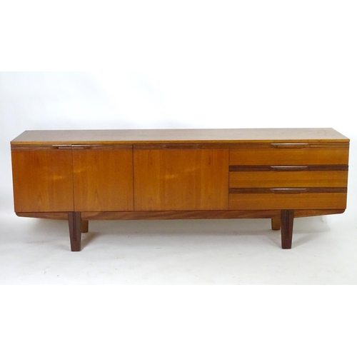 1565 - Vintage retro, mid-century: a large c1970 teak sideboard, in the Danish style, the three compartment... 