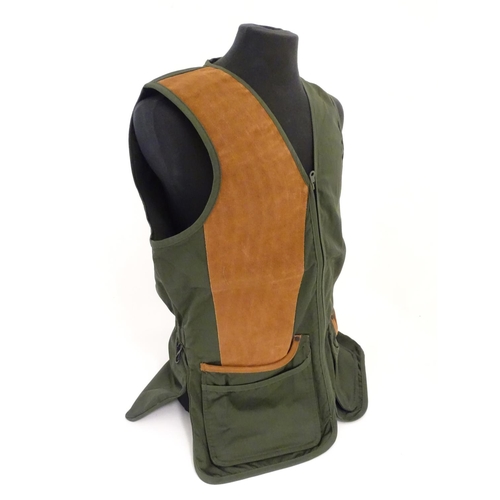 2031 - Sporting / Country pursuits: A Musto skeet vest / clay shooting gilet in green. Size M, new with tag... 