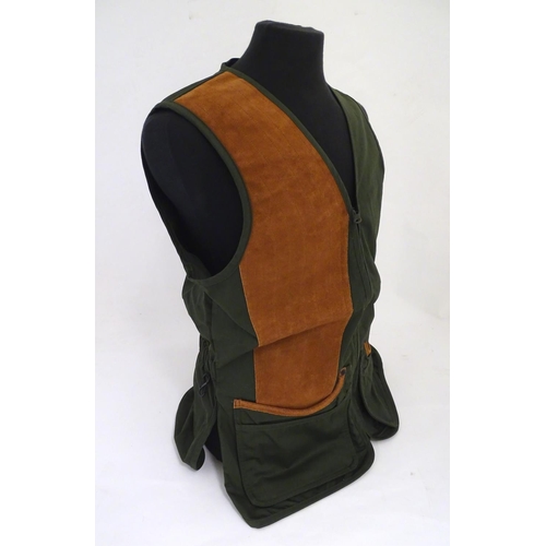 2032 - Sporting / Country pursuits: A Musto skeet vest / clay shooting gilet in green. Size M, new with tag... 