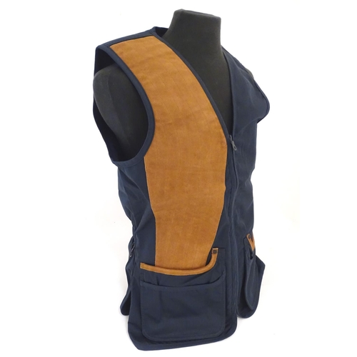 2033 - Sporting / Country pursuits: A Musto skeet vest / clay shooting gilet in Navy. Size M, new with tags... 