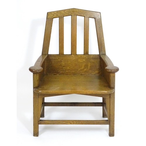 1396 - An Arts and Crafts oak throne chair with a pointed, slatted backrest and a chamfered frame and curve... 