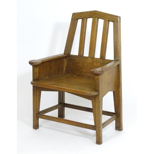 1396 - An Arts and Crafts oak throne chair with a pointed, slatted backrest and a chamfered frame and curve... 