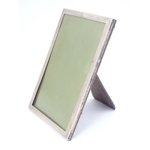 434 - A photograph frame with silver surround, hallmarked Birmingham 1924, maker E Mander Ltd. 7 3/4