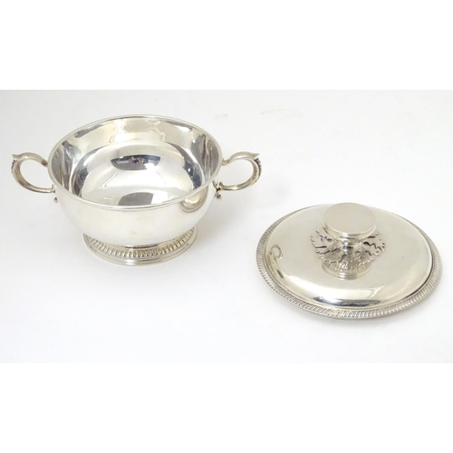 457 - A silver porringer and cover hallmarked London 1964, maker Edward Barnard & Sons Ltd. 
6 1/4