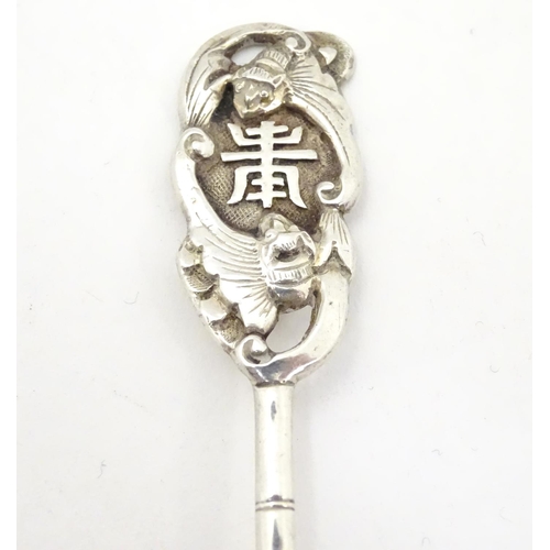 459 - An Oriental white metal teaspoon with stylised bamboo handle surmounted by bat decoration. Marked wi... 