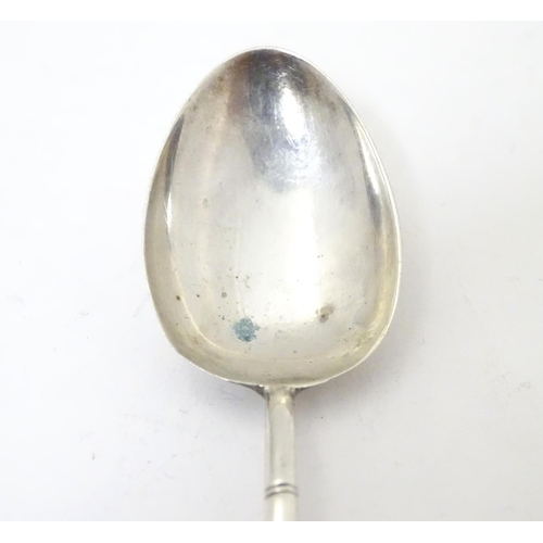 459 - An Oriental white metal teaspoon with stylised bamboo handle surmounted by bat decoration. Marked wi... 