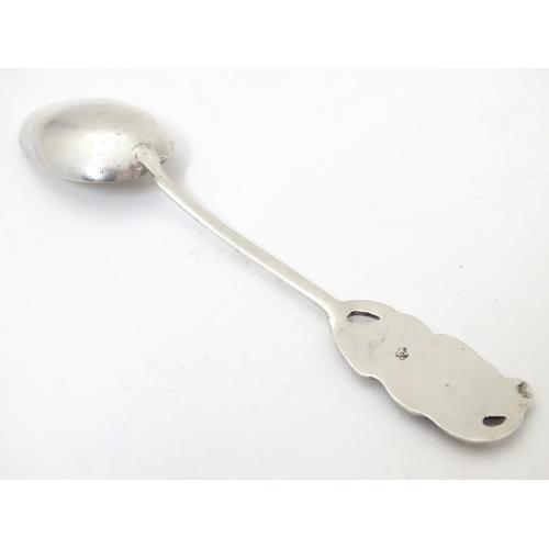 459 - An Oriental white metal teaspoon with stylised bamboo handle surmounted by bat decoration. Marked wi... 