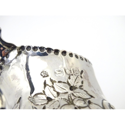 466 - A Victorian silver cream jug with embossed floral and C scroll decoration hallmarked London 1898, ma... 