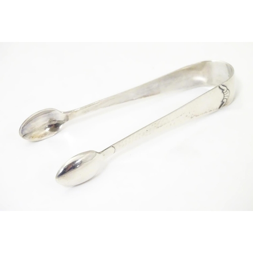 478 - Continental white metal sugar tongs with hammered decoration (4