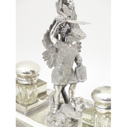 482 - A silver plate standish with central epergne flute supported by cast figure of St George slaying the... 