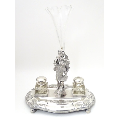 482 - A silver plate standish with central epergne flute supported by cast figure of St George slaying the... 