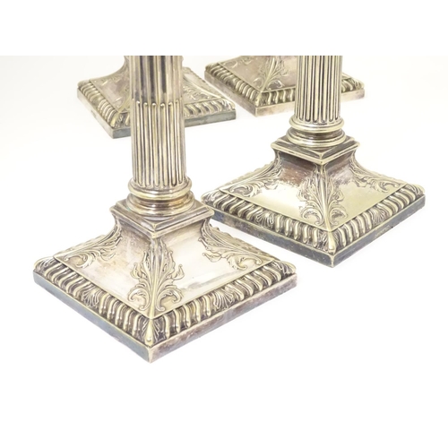 484 - A set of 4 silver plate Corinthian column candlesticks with acanthus detail . Approx 11