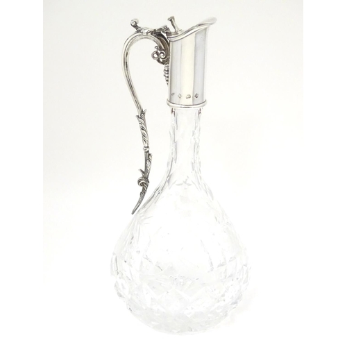 486 - A Silver mounted cut glass claret jug  / ewer with fruiting vine decoration. Hallmarked Birmingham 1... 