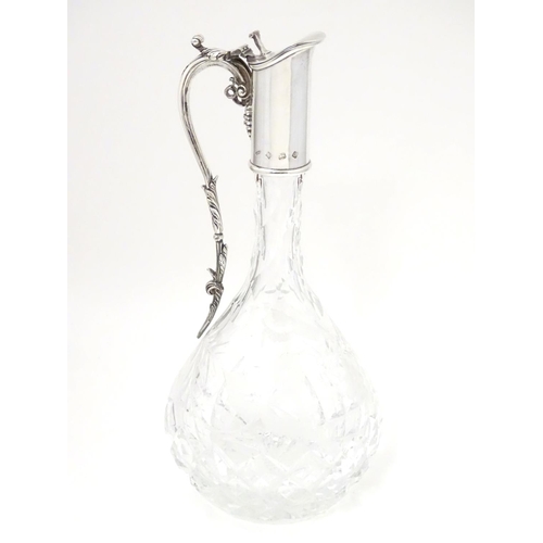 486 - A Silver mounted cut glass claret jug  / ewer with fruiting vine decoration. Hallmarked Birmingham 1... 