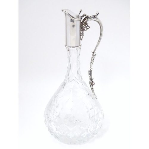 486 - A Silver mounted cut glass claret jug  / ewer with fruiting vine decoration. Hallmarked Birmingham 1... 