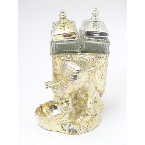 487 - A late 20thC / 21stC novelty cruet formed as  as an elephant carrying pepperettes. Approx 4 1/4