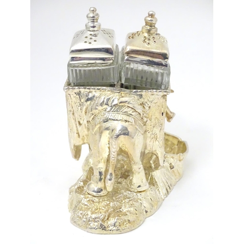 487 - A late 20thC / 21stC novelty cruet formed as  as an elephant carrying pepperettes. Approx 4 1/4