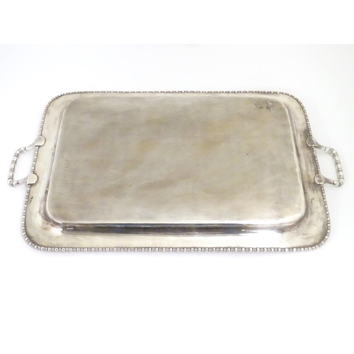 498 - A large silver plate two handled tray with engraved decoration 26