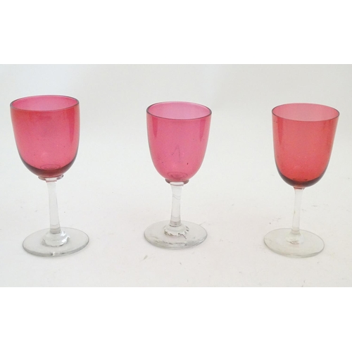 204 - Ten assorted cranberry glass drinking glasses together with two ruby glass drinking glasses with fru... 