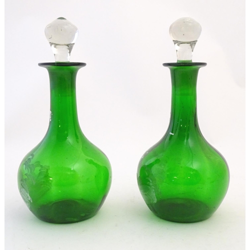 211 - Two Mary Gregory style green glass decanters / carafes with white enamel figural decoration. each ap... 