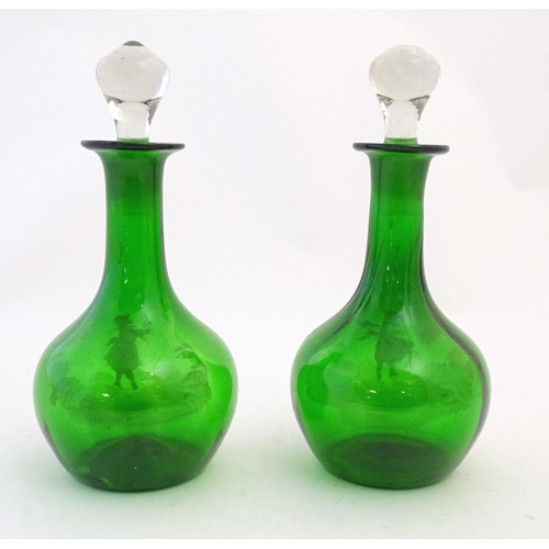 211 - Two Mary Gregory style green glass decanters / carafes with white enamel figural decoration. each ap... 