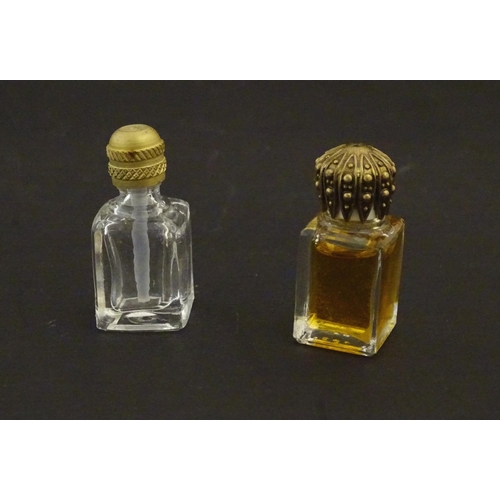 217 - Assorted glass scent bottes together with together with two perfume / scent bottle in enamel contain... 