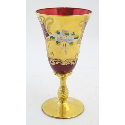 220 - A ruby glass goblet with gilt and enamel overlay. Approx. 7