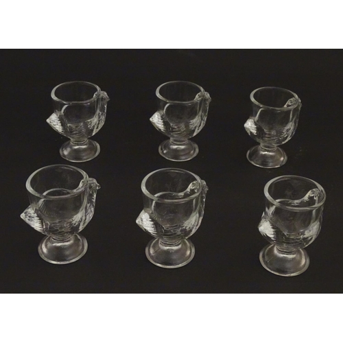 222 - A set of 6 moulded glass egg cups of pedestal form with chicken decoration. 2 3/4