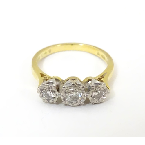 509 - An 18ct gold ring set with trio of diamonds. ring size approx K.