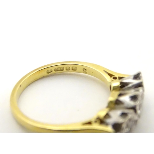 509 - An 18ct gold ring set with trio of diamonds. ring size approx K.