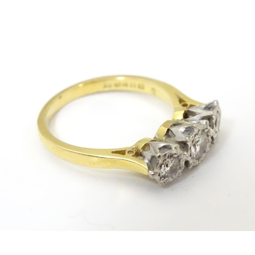 509 - An 18ct gold ring set with trio of diamonds. ring size approx K.