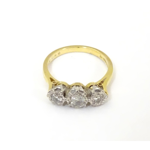 509 - An 18ct gold ring set with trio of diamonds. ring size approx K.