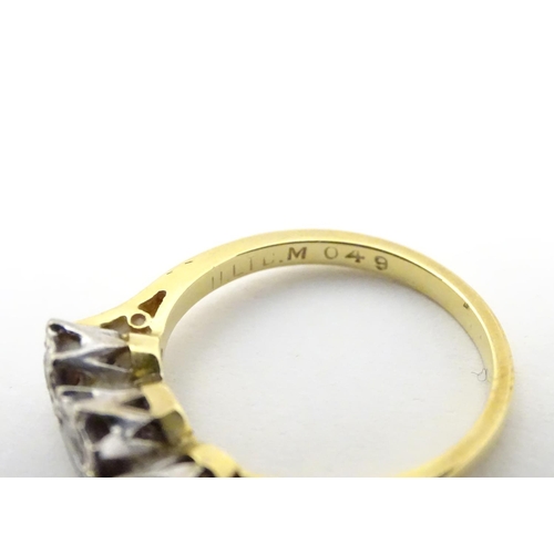 509 - An 18ct gold ring set with trio of diamonds. ring size approx K.