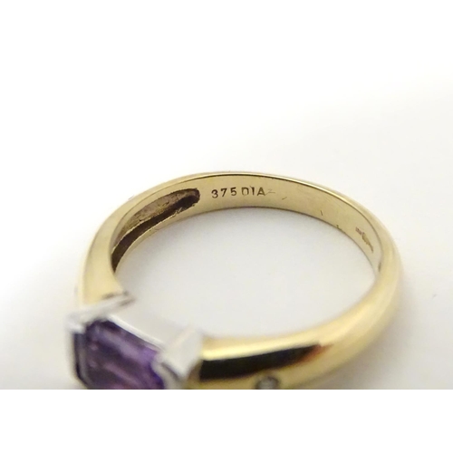 511 - A 9ct gold amethyst and diamond ring, the central amethyst flanked by two diamonds  . Ring size appr... 