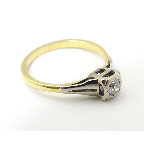 517 - An 18ct gold diamond solitaire ring in a square setting. Ring size approx O