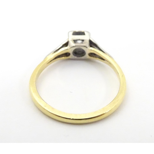 517 - An 18ct gold diamond solitaire ring in a square setting. Ring size approx O