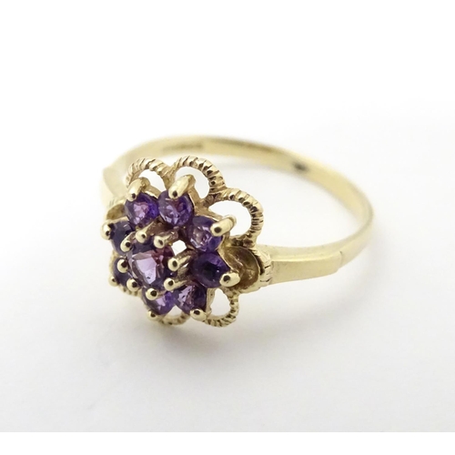 524 - A 9ct gold ring set with amethyst cluster. The ring size approx L.