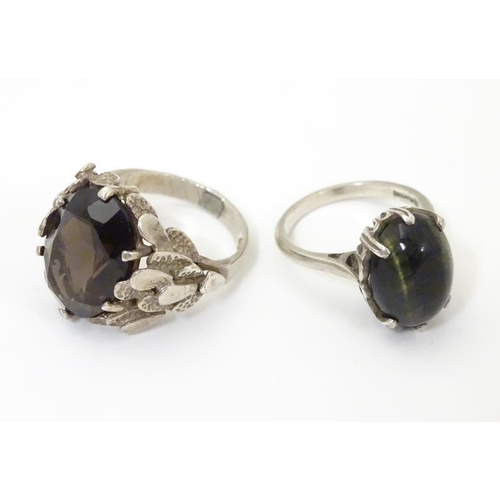 533 - Two silver rings, one set with cats eye cabochon ( ring size approx K) , the other smoky quartz in a... 