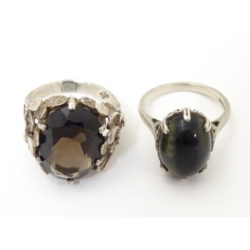 533 - Two silver rings, one set with cats eye cabochon ( ring size approx K) , the other smoky quartz in a... 