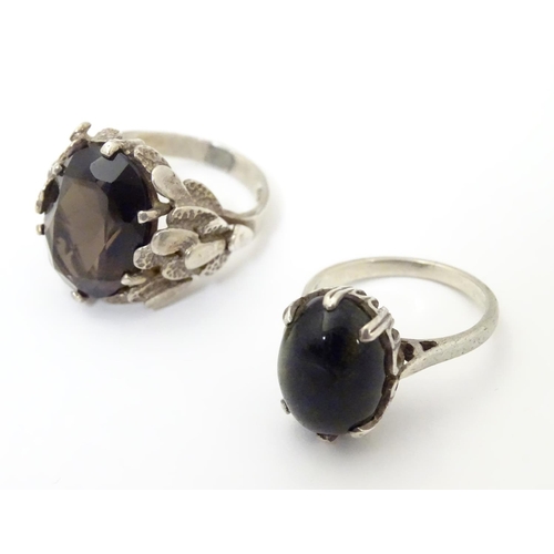 533 - Two silver rings, one set with cats eye cabochon ( ring size approx K) , the other smoky quartz in a... 