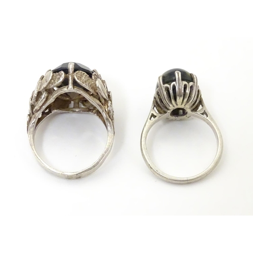 533 - Two silver rings, one set with cats eye cabochon ( ring size approx K) , the other smoky quartz in a... 