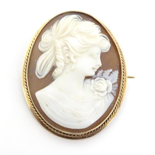 544 - A 20thC shell carved cameo brooch in a 9ct gold mount. 1 1/2