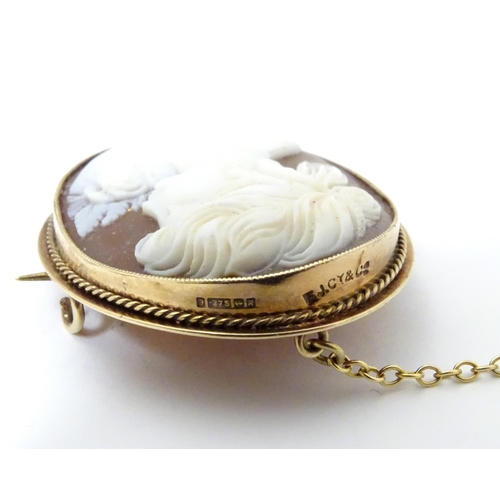 544 - A 20thC shell carved cameo brooch in a 9ct gold mount. 1 1/2