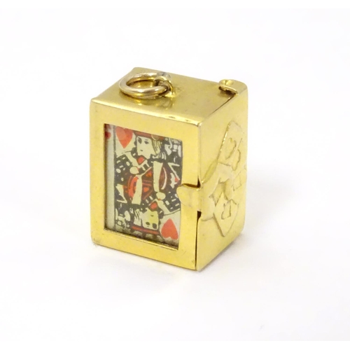 548 - A 9ct gold charm containing a miniature deck of cards 3/4